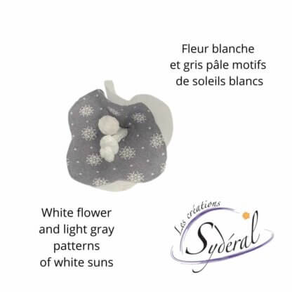 fleur décorative sur épinglette gris pâle motifs de soleils blanc et blanc